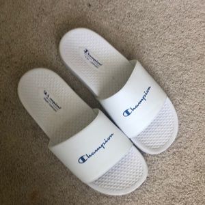 Champion Slides in white letters in blue